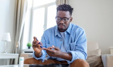 diabetic man poking finger