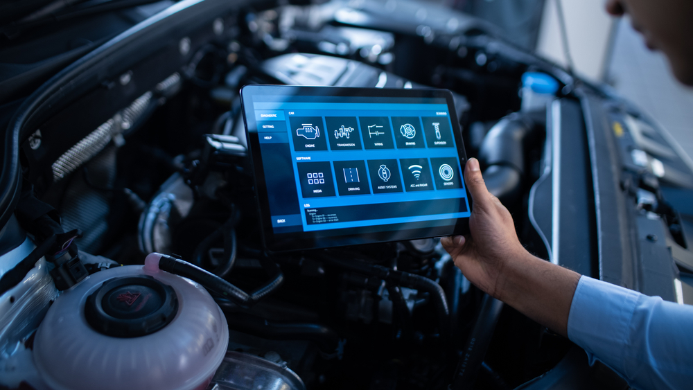 Mechanic uses computer to diagnose car maintenance costs in Georgia