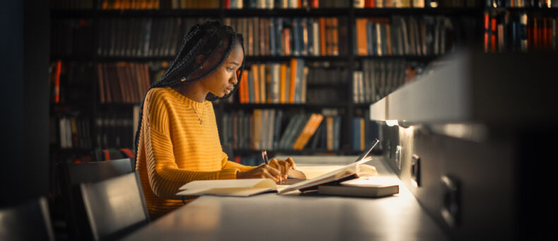 Young African-American girl studys in the college library - cheap renters insurance in Georgia