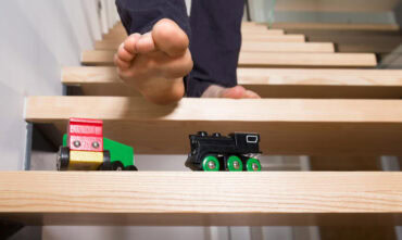 Person's foot on steps, about to step on a toy and fall - cheap home insurance in Georgia.