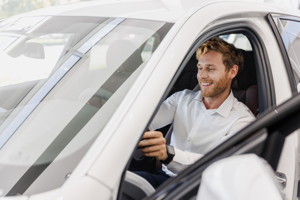 Satisfied smiling man customer buying his new car- Southern Harvest Cheap homeowners in Georgia.