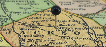 Jackson County, Georgia marked by a black tack on a colorful vintage map. The county seat is located in the city of Jefferson - cheap car insurance in Georgia.
