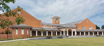Wide view of the Smyrna Community Center with red brick buildings and an open lawn in Smyrna, Georgia