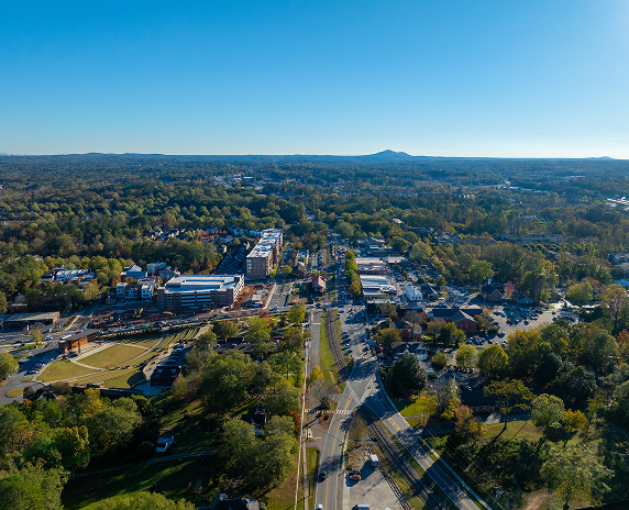 Aerial view of downtown South Fulton, Georgia with tree-lined streets, buildings, and surrounding suburban neighborhoods.