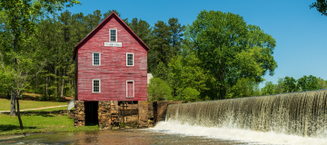 A view of the old building and dam at stars mill pond in Fayetteville Georgia. Cheap car insurance in Georgia.
