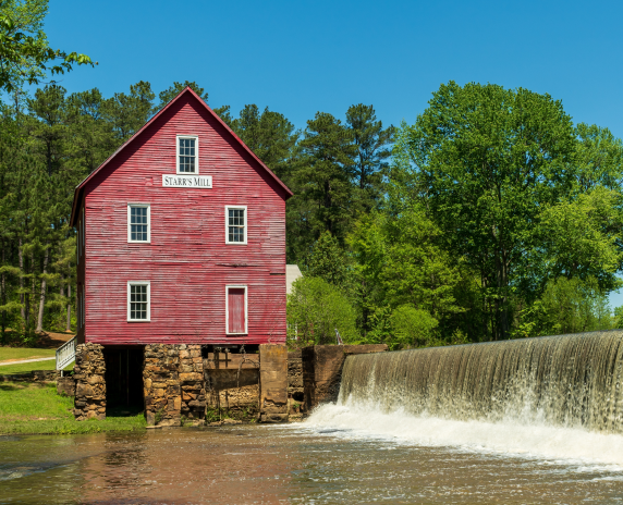 A view of the old building and dam at stars mill pond in Fayetteville Georgia. Cheap car insurance in Georgia.