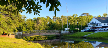 Countryside view of Wooden bridge with reflections at J F Gregory City Park, Richmond Hill, Georgia. Cheap car insurance in Georgia.
